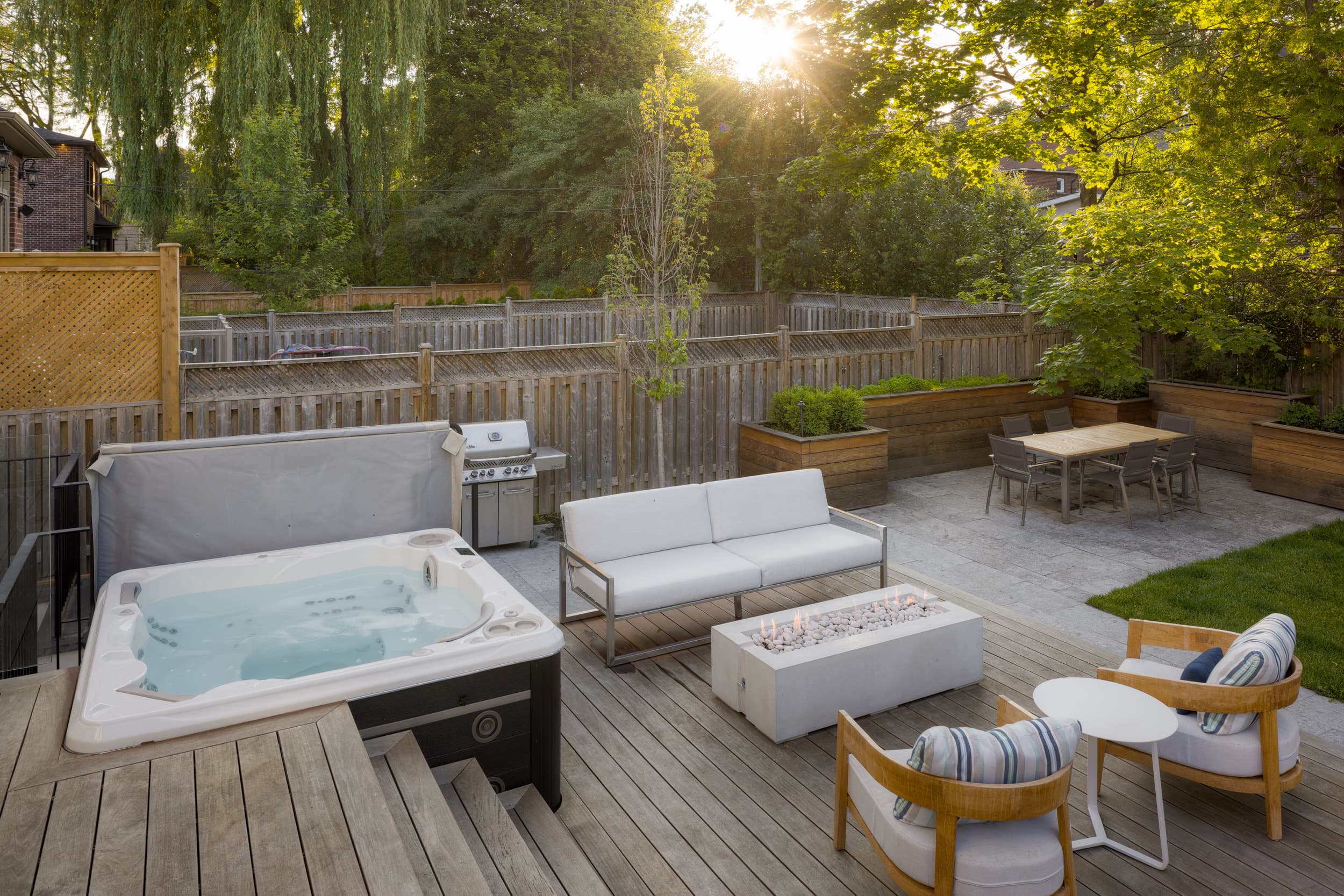 Hydropool hot tub installed in a beautiful Toronto backyard at golden hour